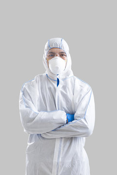 Man in protective suit and gloves with crossed arms