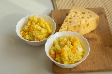 millet porridge with pumpkin and cheese on the table