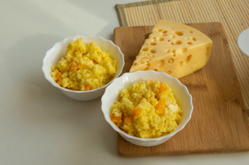 millet porridge with pumpkin and cheese on the table