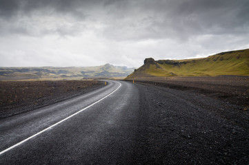 Fototapeta premium Black road with green mountains