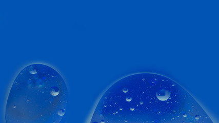 two drops on a blue background, close-up