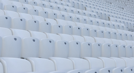 Fototapeta premium Empty white chairs at the soccer stadium during quarantine