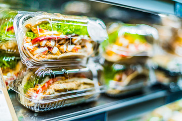 Chicken with pita sandwiches in a commercial refrigerator