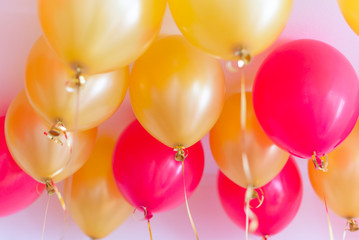 red and gold balloons with helium under the ceiling for a birthday party