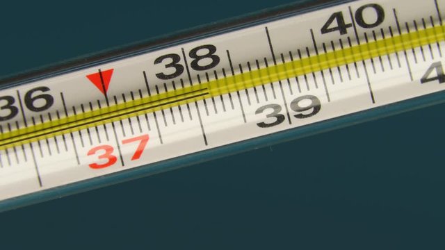 close-up thermometer, mercury, shows a temperature of 38 degrees. Indicates fever and high fever.