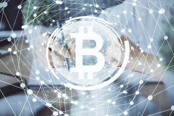 Cryptocurrency hologram, bitcoin, ico theme over hands taking notes background. Concept of blockchain. Multi exposure