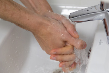 The doctor disinfects the hands. The doctor washes his hands with soap and treats with an antiseptic