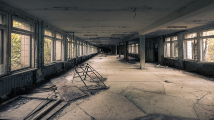 Hallway with open windows in abandoned school in Pripyat near Chernobyl in Ukraine