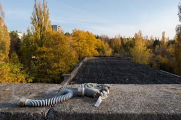 Gasmask lying on roof of abandoned school in Pripyat near Chernobyl in Ukraine