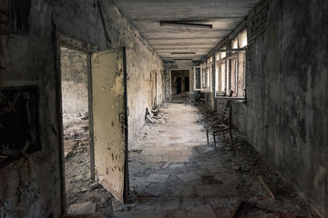 Fototapeta na wymiar Hallway with open windows in abandoned school in Pripyat near Chernobyl in Ukraine
