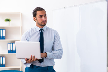 Young male employee in business presentation concept