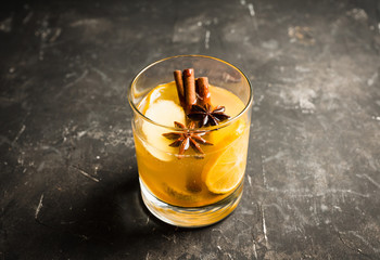 Healthy hot beverage with lemon, ginger and spices for protection in flu season. Selective focus....