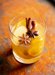 Healthy hot beverage with lemon, ginger and spices for protection in flu season. Selective focus. Shallow depth of field.