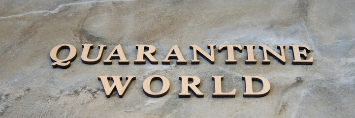 world quarantine , writen wooden letters on stone background