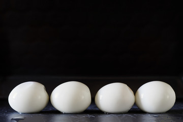 Boiled eggs in a raw with black background