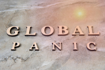 GLOBAL PANIC , writen wooden letters on stone background