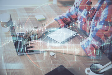Multi exposure of forex graph with man working on computer on background. Concept of market analysis.
