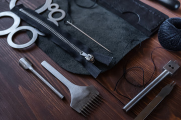 Genuine Leather. Sewing a purse. Leather work. Tools for sewing bags, wallets, clutches. Stitching. Manual sewing of the product. The manufacture of leather products.