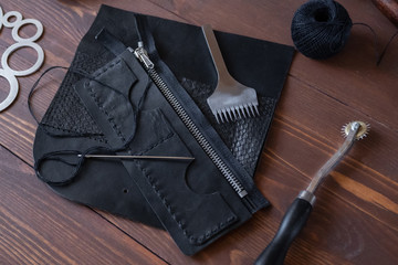 Genuine Leather. Sewing a purse. Leather work. Tools for sewing bags, wallets, clutches. Stitching....