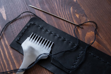 Genuine Leather. Sewing a purse. Leather work. Tools for sewing bags, wallets, clutches. Stitching....