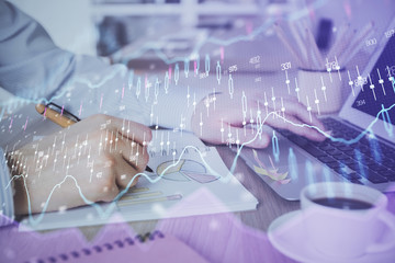 Multi exposure of stock market graph with man working on laptop on background. Concept of financial analysis.
