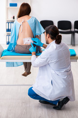 Injured young woman visiting young male doctor