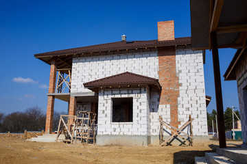 construction of a country two-story house from a gas block