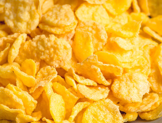 Tasty crispy corn flakes in bowl on the rustic background. Selective focus. Shallow depth of field.