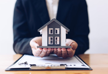 Fototapeta premium Home sales agents and home insurance are protecting and protecting residents with a strict policy ensuring customers with excellent service,Property insurance and security concept.