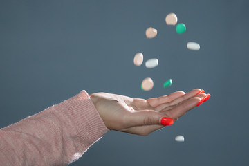 Woman with pills in her hand.
