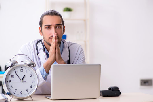 Young handsome male doctor working in the clinic