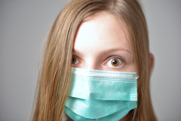 Girl with mask to protect her from Corona virus. Corona virus pandemic. Corona written on mask.