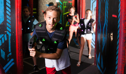 Fototapeta na wymiar Boy having fun on lasertag arena