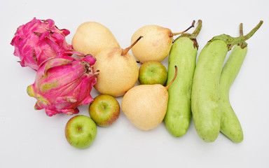 Naklejka na ściany i meble Vegetables and fruit with a white background, dragon fruit, pears, green apples, and eggplants