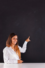 Woman pointing to a blackboard