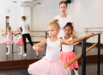 Girls practicing elements on ballet barre