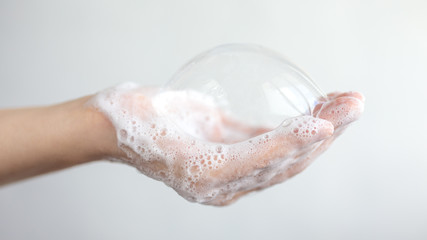 Fototapeta premium Washing hands with foamy soap, protection against coronavirus. Close up