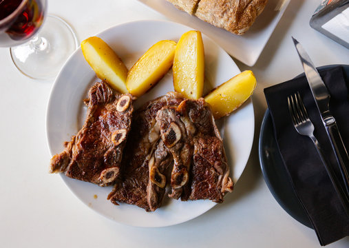 Tasty Veal Kebab And Baked Potatoes Served At Plate