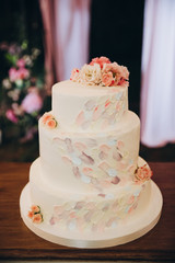 white wedding cake decorated with pink flowers