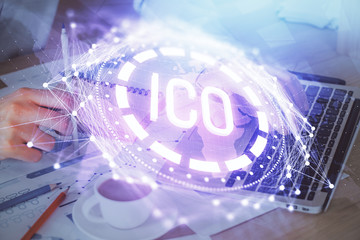 Crypto currency theme hologram with businessman working on computer on background. Concept of blockchain. Double exposure.