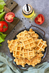 Fish wafers with canned tuna, a quick snack in a plate on a gray stone or concrete countertop. Top view flat lay background.