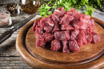 Beef stew prepared on a chopping board.