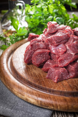 Beef stew prepared on a chopping board.