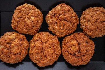 homemade baked oat cookies on black plate