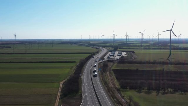 Flying towards A4 autobahn a part of E60 road on Austria Hungarian border with wind turbines on background during quarantine