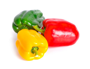 green , yellow and red bell peppers on white background