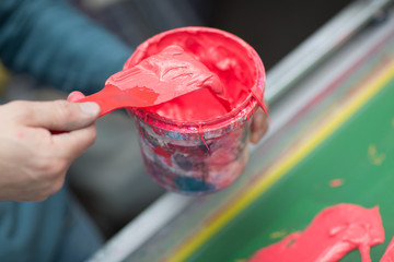 Silk screen printing. Serigraphy. Color paints and fabric. Plastisol paint.
