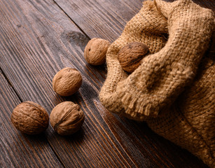walnuts in a canvas bag on a wooden table