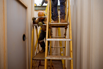 Safe workplace fall prevention concept construction worker wearing safety steel cap boot standing...