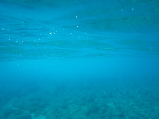 Fototapeta na wymiar Rocky sea floor with reflections of sunlight .